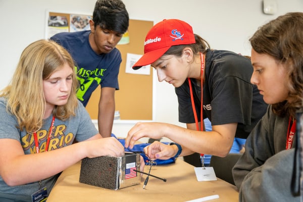 campers building a micro satellite